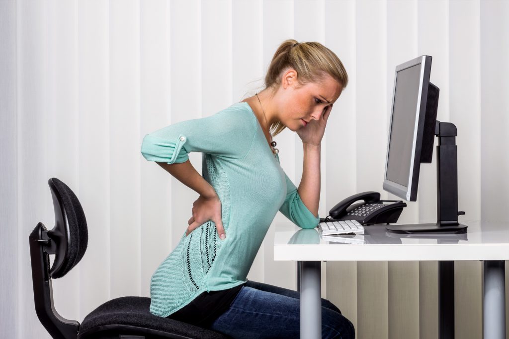 Women at desk with back pain